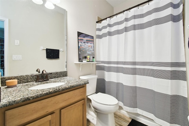 bathroom featuring a shower with shower curtain, toilet, and vanity