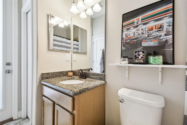 bathroom with toilet and vanity