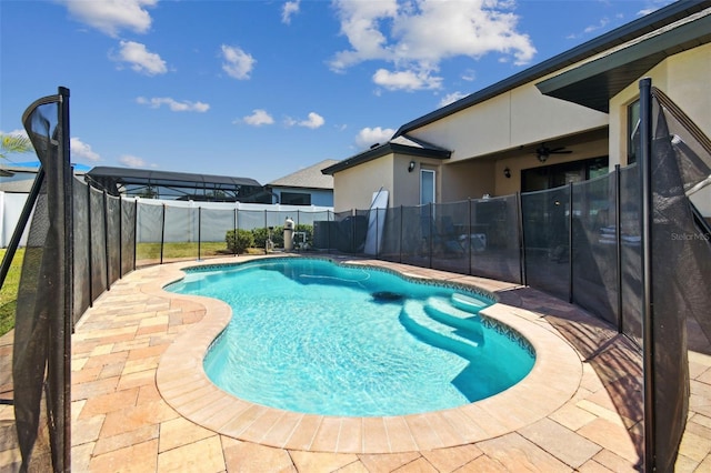 view of pool featuring a ceiling fan, a patio area, a fenced in pool, and a fenced backyard