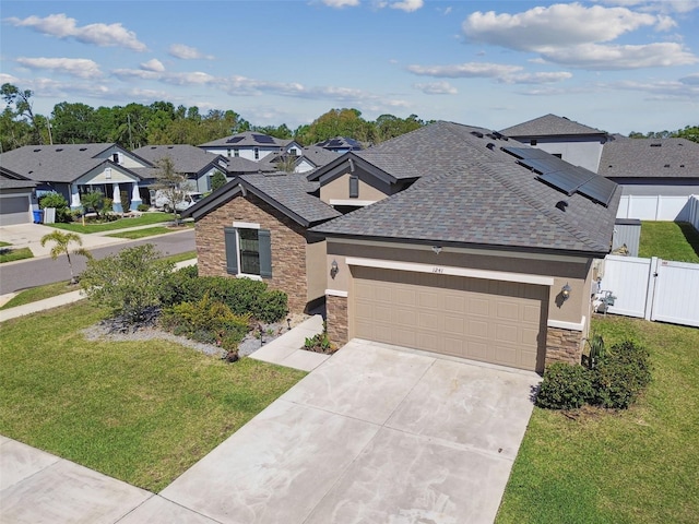 view of front of property with stucco siding, stone siding, a front lawn, and fence