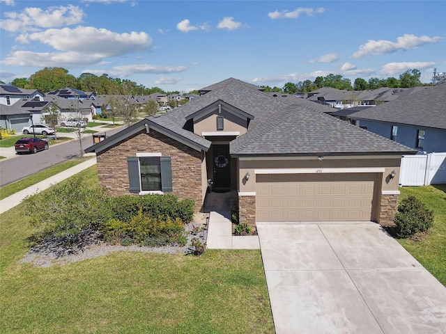 ranch-style house featuring a shingled roof, a residential view, a garage, stone siding, and driveway