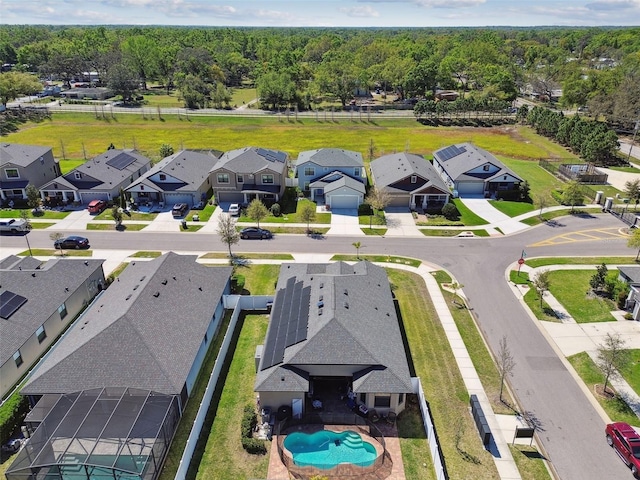 aerial view featuring a forest view and a residential view