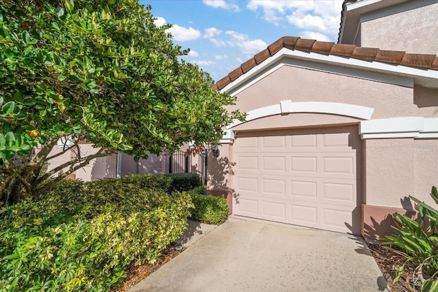 garage featuring concrete driveway