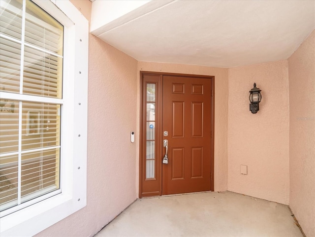 property entrance featuring stucco siding