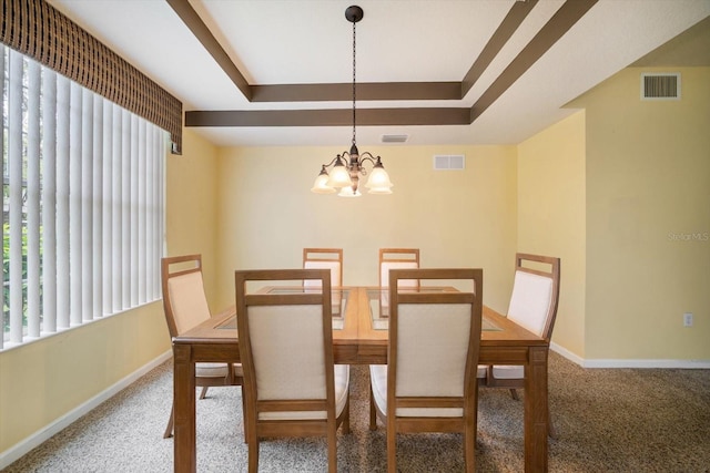 carpeted dining space featuring an inviting chandelier, a tray ceiling, baseboards, and visible vents