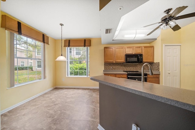 kitchen with baseboards, visible vents, stainless steel range with electric stovetop, black microwave, and backsplash