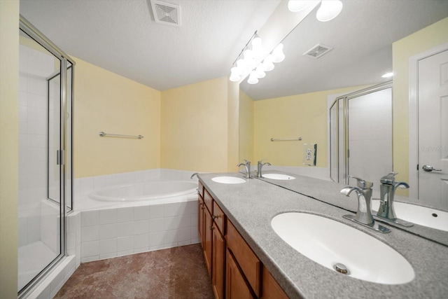 bathroom with a stall shower, visible vents, and a sink