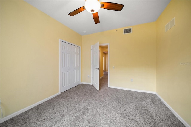 unfurnished bedroom with visible vents, baseboards, carpet floors, and a closet