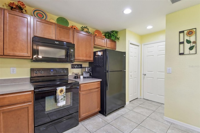 kitchen featuring black appliances, recessed lighting, light countertops, light tile patterned floors, and baseboards