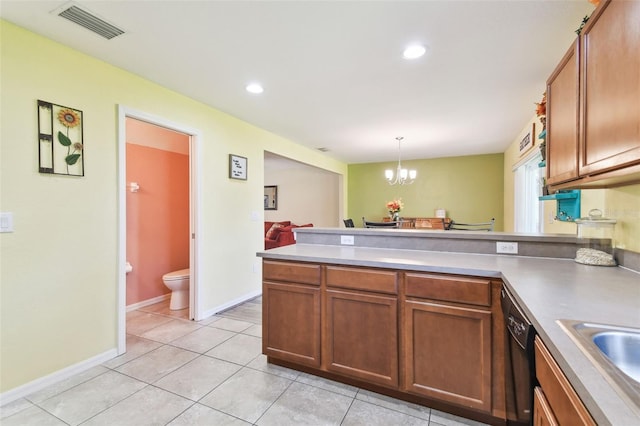 kitchen featuring visible vents, a peninsula, dishwasher, decorative light fixtures, and a chandelier