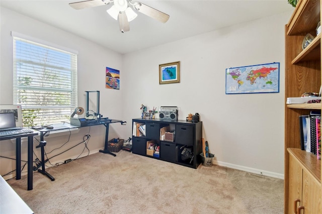 office area featuring ceiling fan, baseboards, and carpet