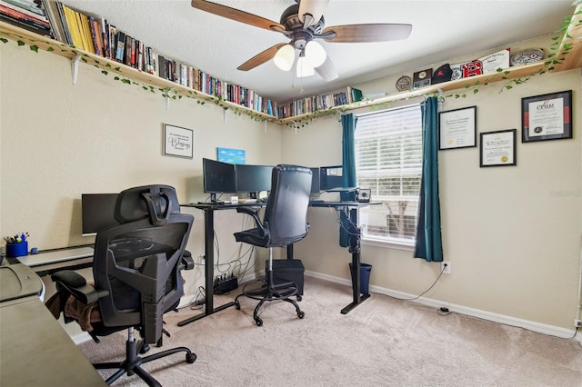 office area featuring baseboards, a ceiling fan, and carpet floors