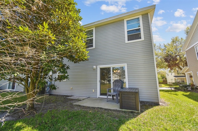 back of house featuring a yard and a patio area