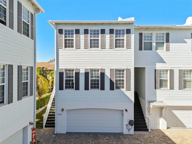 view of front facade with stairway and an attached garage