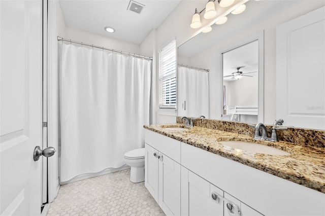 full bathroom with double vanity, visible vents, toilet, and a sink