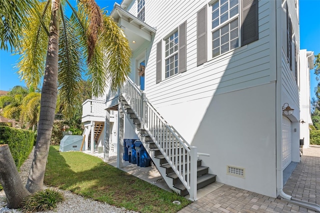 view of home's exterior with stairway and an attached garage