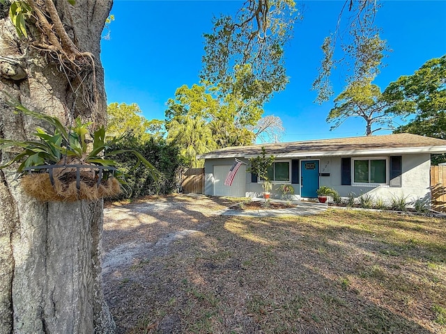 view of front of property with stucco siding and fence