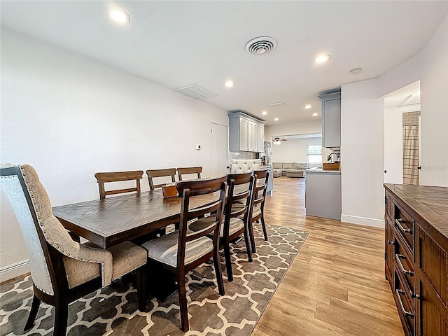 dining space with light wood finished floors, visible vents, recessed lighting, and baseboards