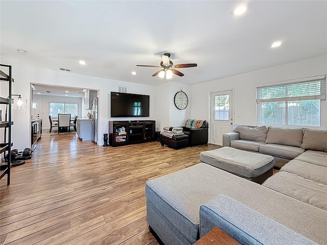 living room with recessed lighting, visible vents, light wood-style flooring, and ceiling fan