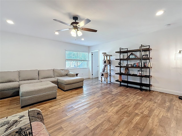 living area with recessed lighting, baseboards, light wood-type flooring, and a ceiling fan