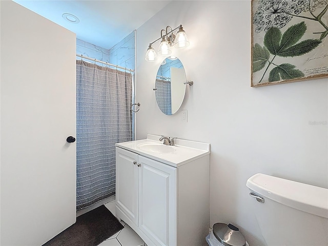 bathroom with toilet, vanity, and a shower with shower curtain