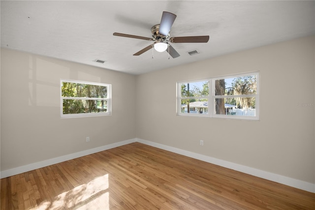 spare room with visible vents, baseboards, a healthy amount of sunlight, and light wood finished floors