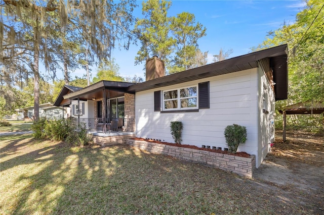 view of front of home featuring a front yard and a chimney