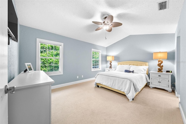 bedroom featuring visible vents, baseboards, light colored carpet, lofted ceiling, and a textured ceiling