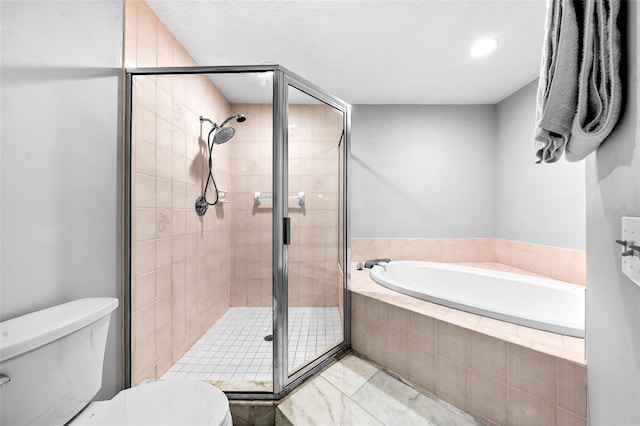 bathroom featuring a stall shower, toilet, and a garden tub