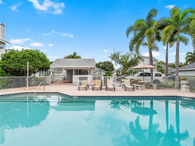 community pool featuring a patio area and fence