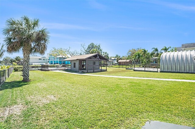 view of yard featuring an outbuilding and fence