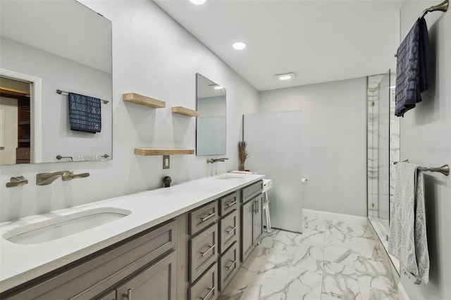 bathroom featuring marble finish floor, a sink, recessed lighting, a marble finish shower, and double vanity