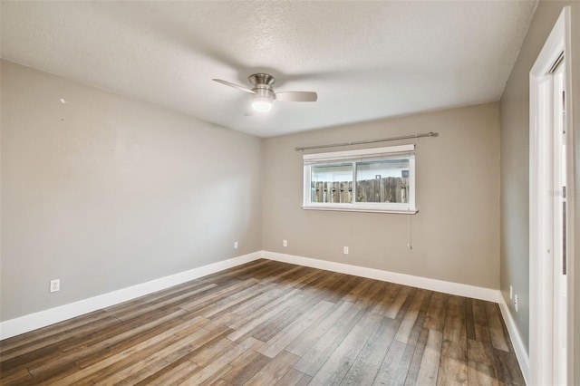 empty room featuring ceiling fan, a textured ceiling, baseboards, and wood-type flooring