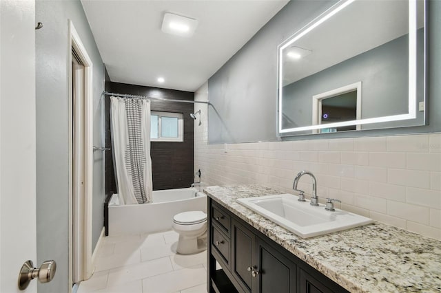 bathroom with tile patterned floors, shower / tub combo with curtain, toilet, tile walls, and vanity