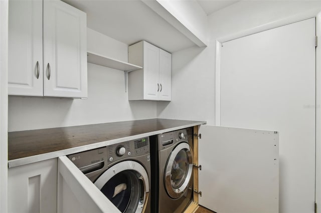 laundry area featuring washer and dryer and cabinet space