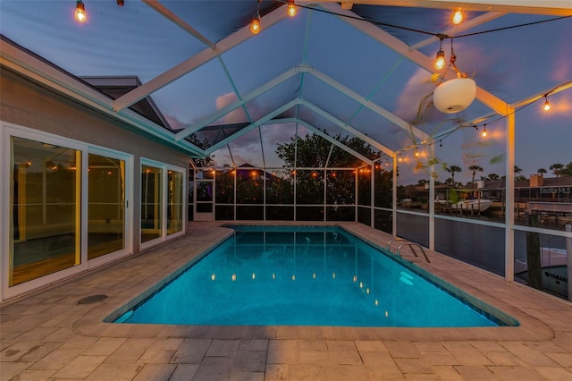 outdoor pool with a lanai and a patio area