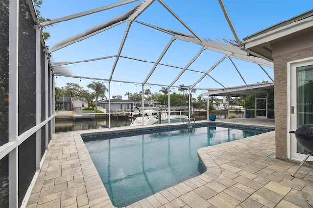 pool with glass enclosure, a patio, a dock, and a water view