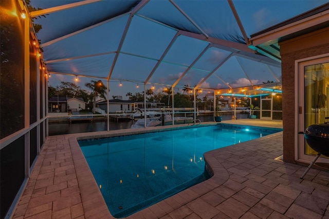 outdoor pool with a lanai and a patio area