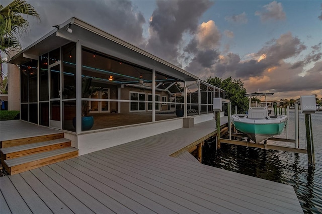 view of dock with glass enclosure and boat lift