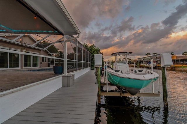 dock area featuring boat lift and a lanai