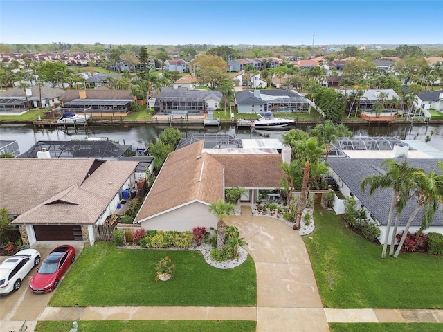 drone / aerial view featuring a residential view and a water view