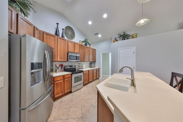 kitchen with light countertops, brown cabinets, light tile patterned flooring, stainless steel appliances, and a sink