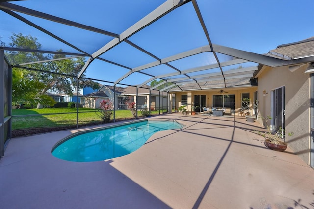 pool featuring a yard, a lanai, a ceiling fan, and a patio area