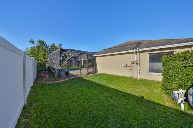 view of yard featuring an outdoor pool, glass enclosure, and a fenced backyard