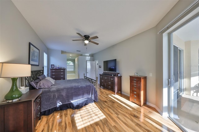 bedroom with light wood-style floors, baseboards, and ceiling fan