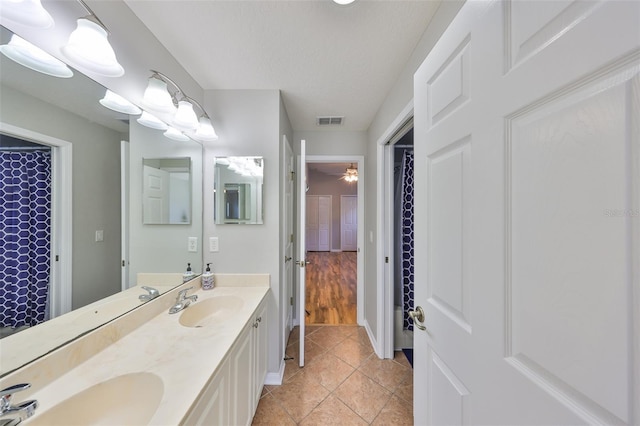 bathroom with tile patterned floors, visible vents, and a sink