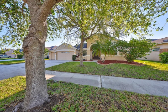 view of front of property featuring a front lawn, a garage, driveway, and stucco siding