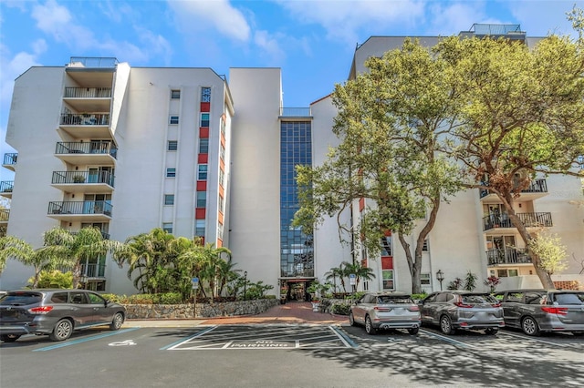 view of building exterior featuring uncovered parking