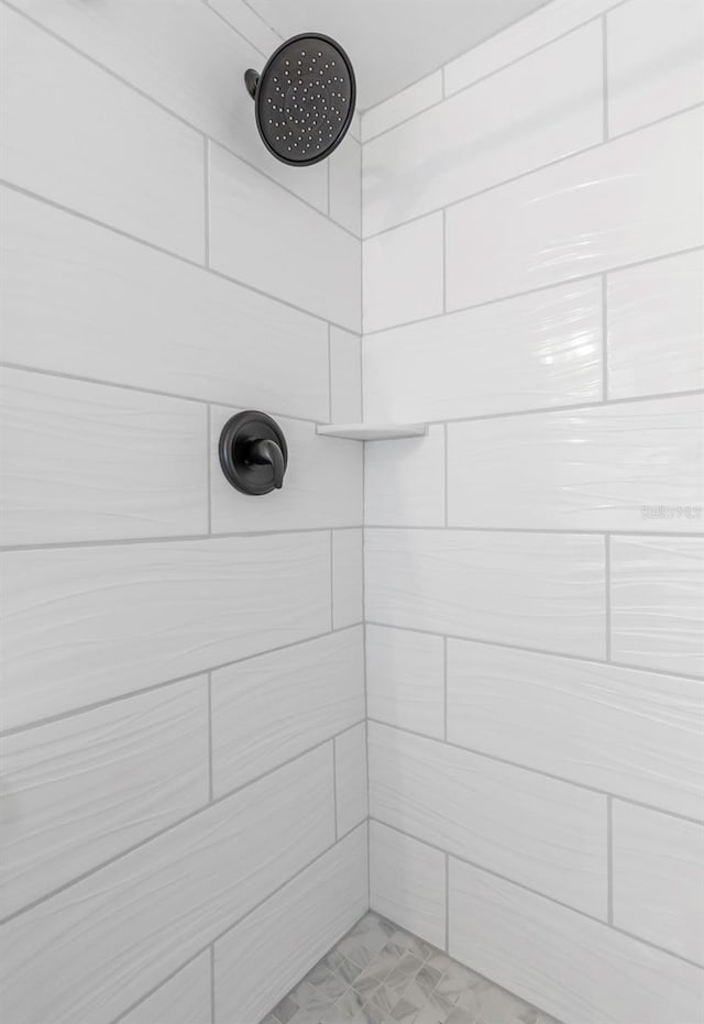 bathroom with a tile shower