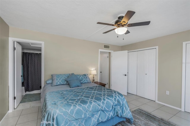 bedroom featuring light tile patterned floors, visible vents, baseboards, and ceiling fan